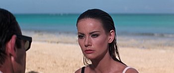 Movie still from “Thunderball” (1965), directed by Terence Young – A person on a beach near the ocean; Close Up shot, Over the shoulder angle