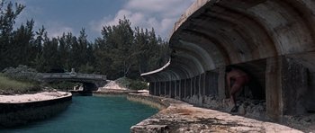 Movie still from “Thunderball” (1965), directed by Terence Young – A view of a body of water with a bridge in the background; Extreme Wide shot, High angle