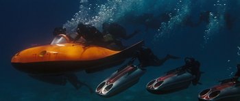 Movie still from “Thunderball” (1965), directed by Terence Young – A group of scuba divers swimming in the ocean; Extreme Wide shot, High angle