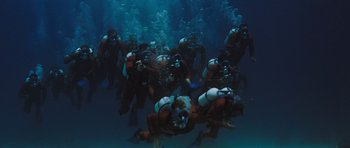 Movie still from “Thunderball” (1965), directed by Terence Young – A group of scuba divers swimming in the ocean; Wide shot, High angle