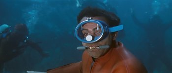 Movie still from “Thunderball” (1965), directed by Terence Young – A man wearing a diving suit and a mask; Medium shot, High angle