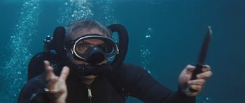 Movie still from “Thunderball” (1965), directed by Terence Young – A man in a scuba mask in the water; Medium shot, High angle