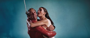 Movie still from “Thunderball” (1965), directed by Terence Young – A man and a woman hugging each other; Medium shot, Low angle