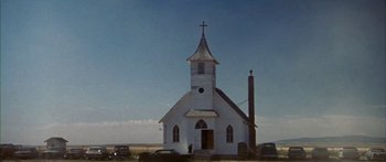 Movie still from “Thunderbolt and Lightfoot” (1974), directed by Michael Cimino – An old church with a steeple on top of it; Extreme Wide shot, Low angle