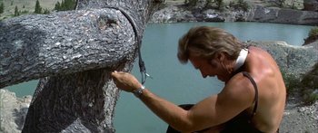 Movie still from “Thunderbolt and Lightfoot” (1974), directed by Michael Cimino – A man holding a pair of scissors next to a tree; Medium shot, Low angle