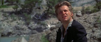 Movie still from “Thunderbolt and Lightfoot” (1974), directed by Michael Cimino – A person wearing a jacket near some trees; Close Up shot, Low angle