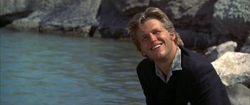 Movie still from “Thunderbolt and Lightfoot” (1974), directed by Michael Cimino – A man smiling while standing in a body of water; Close Up shot, Low angle