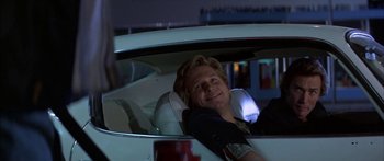 Movie still from “Thunderbolt and Lightfoot” (1974), directed by Michael Cimino – A man sitting in the back seat of a white car; Medium shot, Low angle