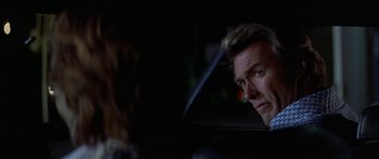 Movie still from “Thunderbolt and Lightfoot” (1974), directed by Michael Cimino – A man and a woman in a car looking at each other; Close Up shot, Over the shoulder angle