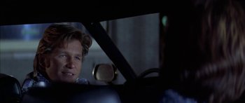 Movie still from “Thunderbolt and Lightfoot” (1974), directed by Michael Cimino – A man sitting in the back seat of a car at night; Close Up shot, Over the shoulder angle