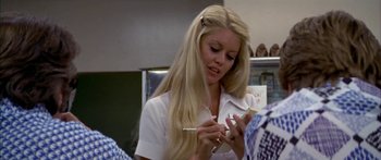 Movie still from “Thunderbolt and Lightfoot” (1974), directed by Michael Cimino – A woman in white shirt holding a cell phone; Close Up shot, Over the shoulder angle