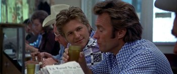 Movie still from “Thunderbolt and Lightfoot” (1974), directed by Michael Cimino – Two men sitting at a table with a glass of beer; Close Up shot, Over the shoulder angle