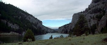 Movie still from “Thunderbolt and Lightfoot” (1974), directed by Michael Cimino – A boat in the middle of a lake surrounded by mountains; Extreme Wide shot, High angle
