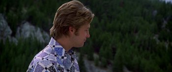 Movie still from “Thunderbolt and Lightfoot” (1974), directed by Michael Cimino – A young man with long blonde hair wearing a blue shirt; Close Up shot, Over the shoulder angle