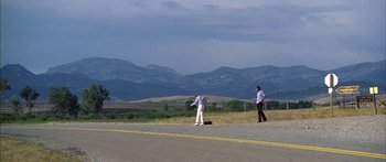 Movie still from “Thunderbolt and Lightfoot” (1974), directed by Michael Cimino – Two people standing on the side of a road; Extreme Wide shot, Low angle