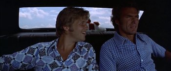 Movie still from “Thunderbolt and Lightfoot” (1974), directed by Michael Cimino – Two men sitting in the back of a car; Close Up shot, Low angle