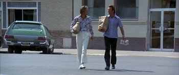 Movie still from “Thunderbolt and Lightfoot” (1974), directed by Michael Cimino – Two men walking down the street holding bags; Wide shot, Low angle