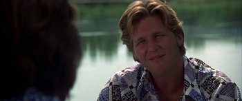 Movie still from “Thunderbolt and Lightfoot” (1974), directed by Michael Cimino – A person sitting in front of a body of water; Close Up shot, Over the shoulder angle