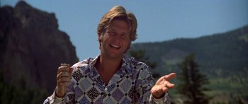 Movie still from “Thunderbolt and Lightfoot” (1974), directed by Michael Cimino – A man in a blue and white shirt is smiling; Close Up shot, Low angle