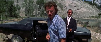 Movie still from “Thunderbolt and Lightfoot” (1974), directed by Michael Cimino – A person wearing a suit and tie; Medium shot, Low angle