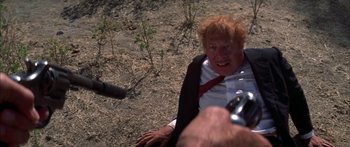 Movie still from “Thunderbolt and Lightfoot” (1974), directed by Michael Cimino – An old man with red hair is being filmed by a photographer; Close Up shot, Over the shoulder angle