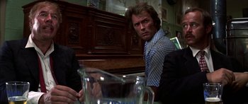 Movie still from “Thunderbolt and Lightfoot” (1974), directed by Michael Cimino – A man sitting in front of a pitcher of water; Close Up shot, Over the shoulder angle