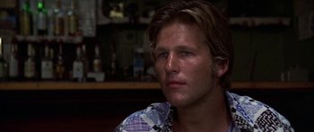 Movie still from “Thunderbolt and Lightfoot” (1974), directed by Michael Cimino – A person sitting in front of a bar; Close Up shot, Low angle