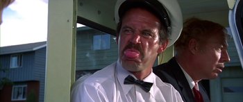 Movie still from “Thunderbolt and Lightfoot” (1974), directed by Michael Cimino – A person wearing a hat and a bow tie; Close Up shot, Low angle