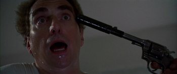 Movie still from “Thunderbolt and Lightfoot” (1974), directed by Michael Cimino – A person holding a stick over their head; Close Up shot, Low angle