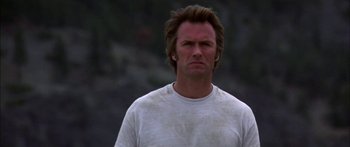 Movie still from “Thunderbolt and Lightfoot” (1974), directed by Michael Cimino – A person wearing a white t - shirt; Close Up shot, Low angle