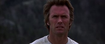 Movie still from “Thunderbolt and Lightfoot” (1974), directed by Michael Cimino – A person wearing a white t - shirt; Close Up shot, Low angle