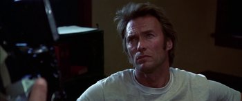 Movie still from “Thunderbolt and Lightfoot” (1974), directed by Michael Cimino – A person sitting in a room; Close Up shot, Low angle