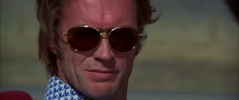 Movie still from “Thunderbolt and Lightfoot” (1974), directed by Michael Cimino – A person wearing sunglasses; Close Up shot, Low angle
