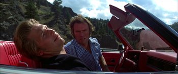 Movie still from “Thunderbolt and Lightfoot” (1974), directed by Michael Cimino – A man and a woman sitting in the back of a car; Medium shot, Low angle