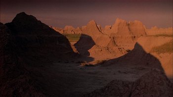 Movie still from “Thunderheart” (1992), directed by Michael Apted – A view of a mountain range in the middle of the desert; Extreme Wide shot, High angle