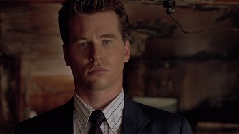 Movie still from “Thunderheart” (1992), directed by Michael Apted – A person wearing a suit and tie; Close Up shot, Low angle