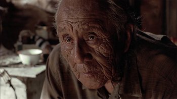 Movie still from “Thunderheart” (1992), directed by Michael Apted – An old man with wrinkled skin looking into the camera; Close Up shot, Low angle