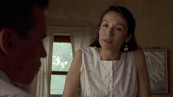 Movie still from “Thunderheart” (1992), directed by Michael Apted – A woman in a white shirt is talking to a man in front of a window; Close Up shot, Over the shoulder angle