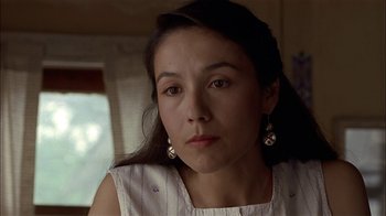Movie still from “Thunderheart” (1992), directed by Michael Apted – A person wearing a white shirt; Close Up shot, Over the shoulder angle