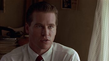 Movie still from “Thunderheart” (1992), directed by Michael Apted – A person wearing a shirt and tie; Close Up shot, Over the shoulder angle