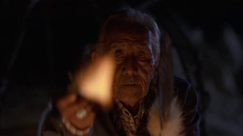 Movie still from “Thunderheart” (1992), directed by Michael Apted – An old man is holding a candle in his hand; Close Up shot, Low angle