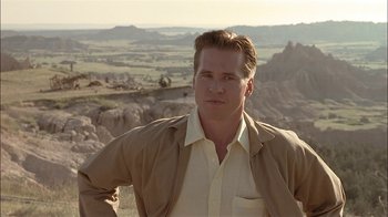 Movie still from “Thunderheart” (1992), directed by Michael Apted – A man standing on top of a hill in a field; Medium shot, Low angle