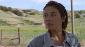 Movie still from “Thunderheart” (1992), directed by Michael Apted – A woman in a denim jacket looking to her left; Close Up shot, Low angle