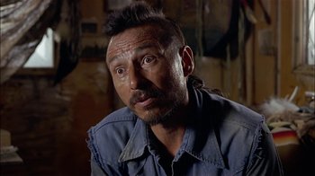 Movie still from “Thunderheart” (1992), directed by Michael Apted – A person wearing a blue shirt; Close Up shot, Over the shoulder angle