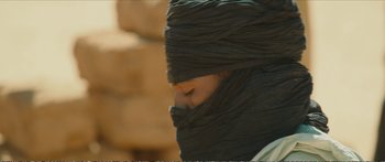 Movie still from “Timbuktu” (2014), directed by Abderrahmane Sissako – A woman with a black head covering covering her face; Close Up shot, Over the shoulder angle