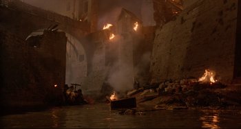 Movie still from “Time Bandits” (1981), directed by Terry Gilliam – A fire burning in the middle of the night; Extreme Wide shot, High angle