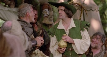 Movie still from “Time Bandits” (1981), directed by Terry Gilliam – A man dressed as robin hood talking to another man in medieval garb; Medium shot, Over the shoulder angle