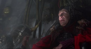 Movie still from “Time Bandits” (1981), directed by Terry Gilliam – A man in a red jacket and a man in a black helmet; Medium shot, Low angle