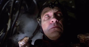 Movie still from “Time Bandits” (1981), directed by Terry Gilliam – A person wearing a helmet and holding something; Close Up shot, Low angle