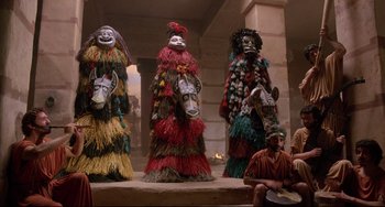 Movie still from “Time Bandits” (1981), directed by Terry Gilliam – A group of people sitting on top of a platform; Wide shot, Low angle